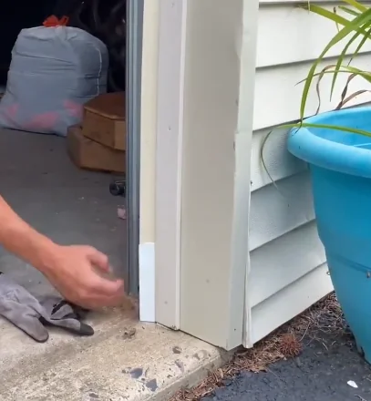 New rodent-resistant seal being fitted along the side of a garage door