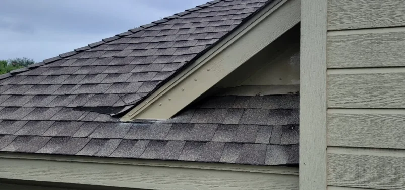 Open gap at a gable where a lower roof meets the wall
